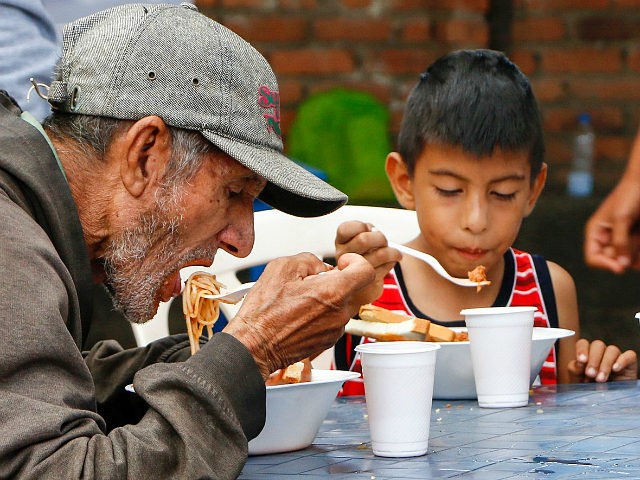 Venezuelans get food at the Casa de Paso Divina Providencia refuge in Cucuta, Colombia on July 31, 2017. The United States, Mexico, Colombia, Peru and other nations said they did not recognize the results of the election Sunday of a new 'Constituent Assembly' superseding Venezuela's legislative body, the opposition-controlled National …