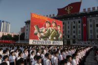 North Koreans wave banners and shout slogans at a state organised anti-American rally in  Pyongyang