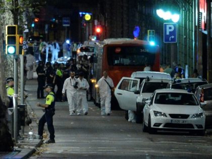 Forensic policemen arrive in the cordoned off area on Las Ramblas in Barcelona on August 17, 2017 after a van ploughed into the crowd, killing 13 people and injuring over 80