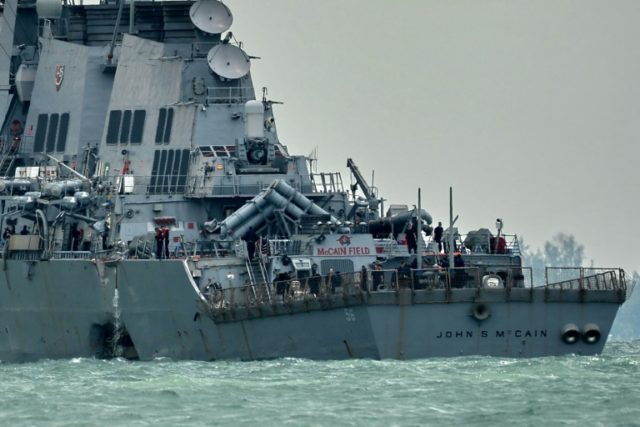 The guided-missile destroyer USS John S. McCain, with a hole on its portside after a colli