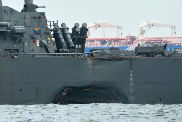 The USS John S. McCain with a hole on its port side