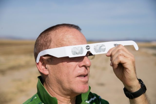 Martin Ferreira, a total eclipse enthusiast, tries out protective eyewear while waiting ou