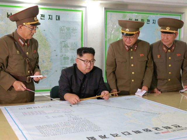 North Korean leader Kim Jong-Un (C) ast week delayed the Guam strike plan, but warned it c
