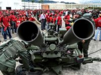 Members of Venezuela's army show civilians how to handle an anti-aircraft battery during military drills