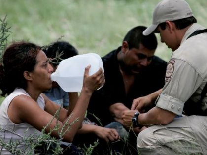 Border Patrol BORSTAR agent administers basic medical attention to illegal immigrants abandoned near Falfurrias, Texas. (AP Photo/Eric Gay)
