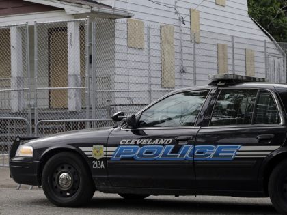 A Cleveland police patrol car sits in front of the boarded up home of Ariel Castro in Cleveland Tuesday, May 14, 2013. Three women were rescued from the house last week after a decade in captivity. Castro is under arrest and charged with rape and kidnapping. (AP Photo/Mark Duncan)