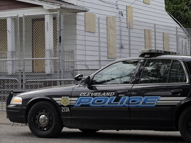 A Cleveland police patrol car sits in front of the boarded up home of Ariel Castro in Clev