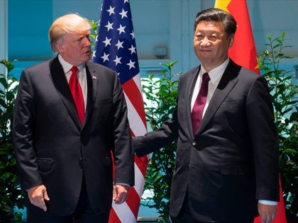 US President Donald Trump and Chinese President Xi Jinping (R) arrive prior to a meeting o