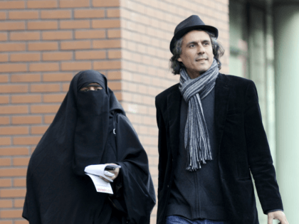 French businessman Rachid Nekkaz (R) walks with Kenza Drider (R), candidate for the 2012 French presidential election, on December 12, 2011 in Paris, after Drider appeared at the police tribunal for violating France's niqab ban. Since a burqa and niqab ban came into force in France with the threat of …