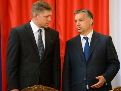 Slovakian Prime Minister Robert Fico (L) chats with his Hungarian counterpart Viktor Orban (R) in Delegation Hall of the parliament building in central Budapest on July 2, 2013 prior to their joint press conference. Orban meets with Fico for his one-day working visit. AFP PHOTO / ATTILA KISBENEDEK (Photo credit …