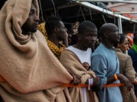 POZZALLO, ITALY - FEBRUARY 19: Refugees and migrants wait on deck of the Spanish NGO Proactiva Open Arms rescue vessel Golfo Azzurro to disembark after being rescued off Libyan coast north of Sabratha, Libya on February 19, 2017 in Pozzallo, Italy. 466 migrants were rescued in high seas last Friday …