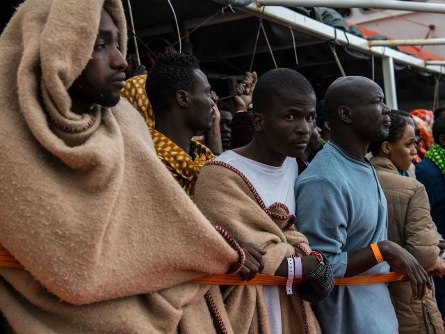 POZZALLO, ITALY - FEBRUARY 19: Refugees and migrants wait on deck of the Spanish NGO Proac