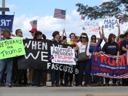 WEST PALM BEACH, FL - MARCH 04: Supporters of President Donald Trump and people against his presidency stand near each other down the road from the Mar-a-Lago resort home of President Trump on March 4, 2017 in West Palm Beach, Florida. President Trump spent part of the weekend at the …