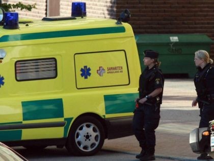 Stockholm, SWEDEN: Police and ambulance are seen 02 July 2006 at the site where a man opened fire with an automatic weapon and wounded a woman in the leg in the north of Stockholm. Police mounted a huge operation and later found the gunman dead in the elevator of an …