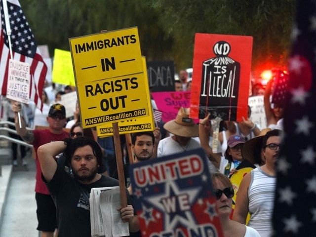 Immigrants and supporters chant during a "We Rise for the Dream" rally to oppose U.S. Pres