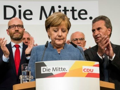 German Chancellor and CDU party leader Angela Merkel (C) addresses supporters after exit poll results were broadcasted on public television at an election night event at the party's headquarters in Berlin during the general election on September 24, 2017. Germany voted in a general election expected to hand Chancellor Angela …