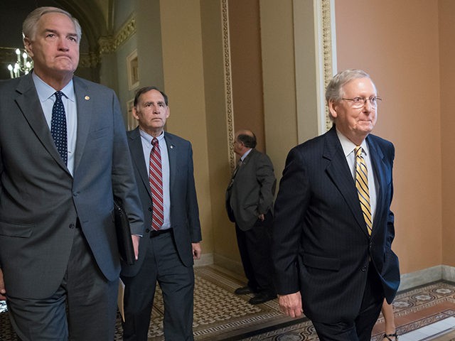 Senate Budget Committee members Sen. Luther Strange, R-Ala., left, and Sen. John Boozman, R-Ark., center, walk with Senate Majority Leader Mitch McConnell, R-Ky, right, as they leave a closed-door meeting with Treasury Secretary Steven Mnuchin after working on a tax code overhaul, at the Capitol in Washington, Tuesday, Sept. 12, …
