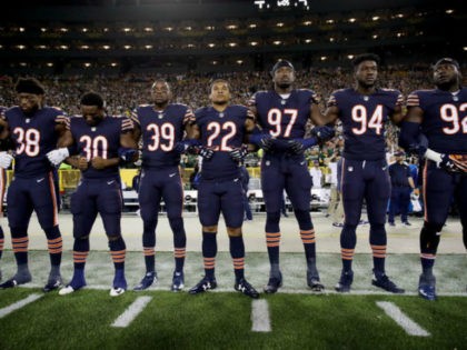 Members of the Chicago Bears link arms during the singing of the national anthem before the game against the Green Bay Packers at Lambeau Field on September 28, 2017 in Green Bay, Wisconsin. (Photo by Jonathan Daniel/Getty Images)