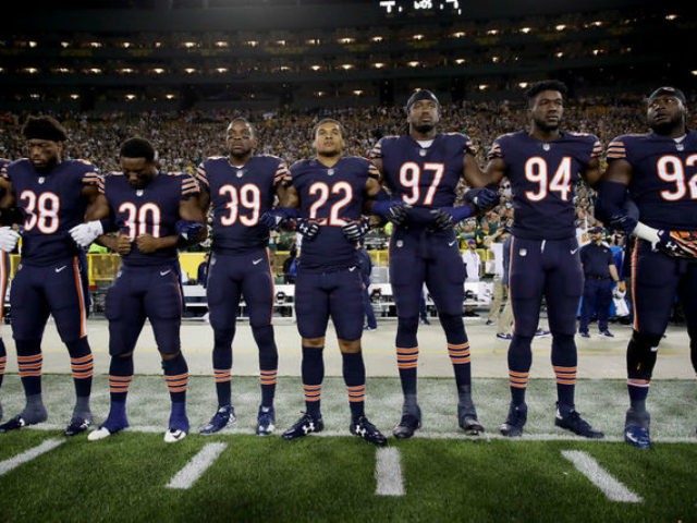 Members of the Chicago Bears link arms during the singing of the national anthem before the game against the Green Bay Packers at Lambeau Field on September 28, 2017 in Green Bay, Wisconsin. (Photo by Jonathan Daniel/Getty Images)
