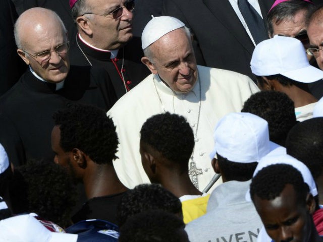 Pope Francis (C) speaks to migrants during his visit to the island of Lampedusa, a key destination of tens of thousands of would-be immigrants from Africa, on July 8, 2013. Pope Francis called for an end to 'indifference' to the plight of refugees on Monday on a visit to an …