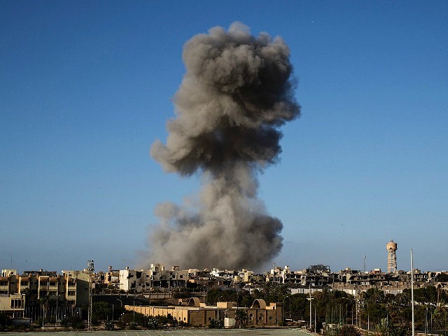 TOPSHOT - Smoke rise after an airstrike on the District 3 of Sirte, the last stronghold of