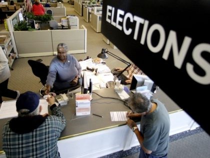 Voters drop their voters registration at Multnomah County Elections Office Tuesday, Oct. 14, 2008, in Portland, Ore., on the final day for voter registration in Oregon. (AP Photo/Rick Bowmer)