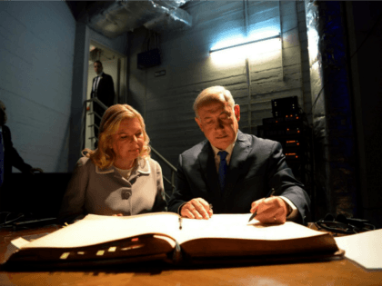 In this picture released by the Israeli Government Press Office, Israeli Prime Minister Benjamin Netanyahu, right, and his wife Sara sign the visitors book at the AMIA Jewish community center in Buenos Aires, Argentina, Monday, Sept. 11, 2017. The bombing of the Argentine-Israeli Mutual Association in downtown Buenos Aires killed …
