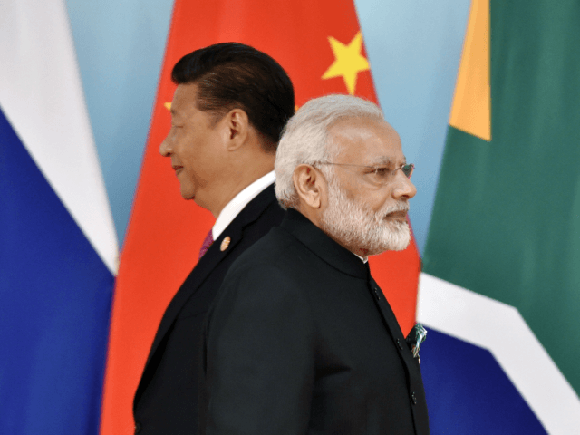 China 's President Xi Jinping (L) and Indian Prime Minister Narendra Modi attend the group photo session during the BRICS Summit at the Xiamen International Conference and Exhibition Center in Xiamen, southeastern China's Fujian Province on September 4, 2017. Xi opened the annual summit of BRICS leaders that already has …