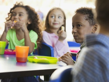 Children eating snacks in elementary school classroom