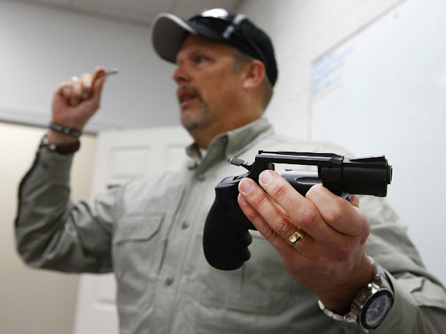 SPRINGVILLE, UT - JANUARY 9: Gun instructor Mike Stilwell, demonstrates a revolver as as he teaches a packed class to obtain the Utah concealed gun carry permit, at Range Master of Utah, on January 9, 2016 in Springville, Utah. Utahs permits, available for a fee to non-residents who meet certain …