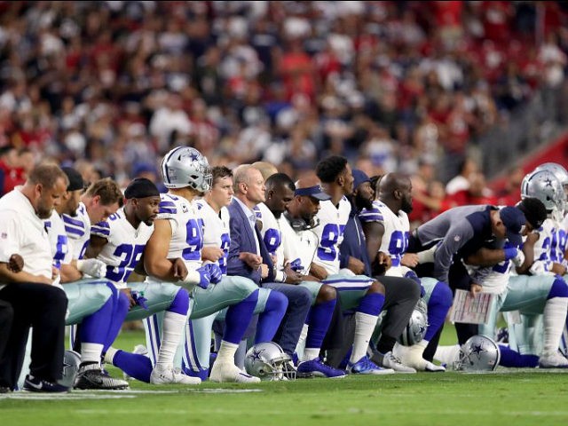 dallas-cowboys-link-arms-take-a-knee-during-national-anthem-getty