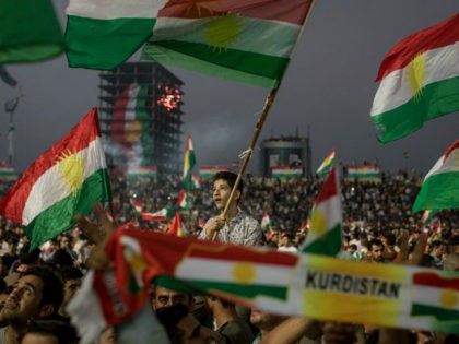 ERBIL, IRAQ - SEPTEMBER 22: Supporters wave flags and chant slogans inside the Erbil Stadi