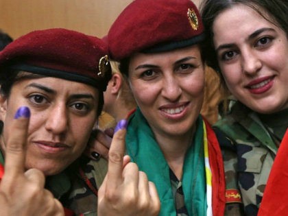 Female members of a Kurdish Peshmerga battalion show their ink-stained fingers after casting their vote in the Kurdish independence referendum in Arbil, on September 25, 2017. Iraqi Kurds voted in an independence referendum in defiance of Baghdad which has warned of 'measures' to defend Iraq's unity and threatened to deprive …