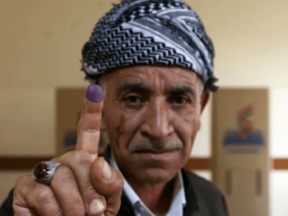 An Iraqi Kurd shows off his ink-stained finger after voting on Iraqi Kurdistan's independence in regional capital Arbil