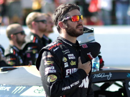 LOUDON, NH - SEPTEMBER 24: Martin Truex Jr., driver of the #78 Furniture Row/Denver Mattress Toyota, stands during the national anthem prior to the Monster Energy NASCAR Cup Series ISM Connect 300 at New Hampshire Motor Speedway on September 24, 2017 in Loudon, New Hampshire. (Photo by Chris Graythen/Getty Images)