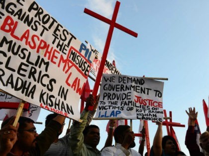 Pakistani Christians shout slogans in protest against the killing of Christian couple, in