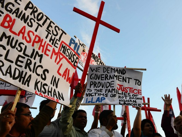 Pakistani Christians shout slogans in protest against the killing of Christian couple, in Islamabad on November 5, 2014. An enraged Muslim mob beat a Christian couple to death in Pakistan and burnt their bodies in the brick kiln where they worked for allegedly desecrating a Koran, police said. AFP PHOTO/Farooq NAEEM (Photo credit should read FAROOQ NAEEM/AFP/Getty Images)