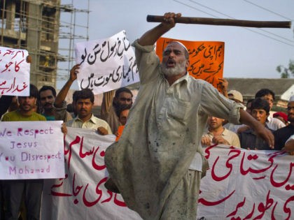 A Pakistani worker shouts anti U.S. slogans during a rally in Islamabad, Pakistan on Saturday, Sept. 15, 2012 as part of widespread anger across the Muslim world about a film ridiculing Islam's Prophet Muhammad. The banner at bottom reads, "'immediately hang the cursed man indulged in insulting the Prophet," while …