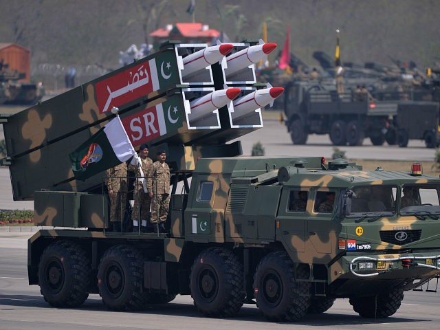 Pakistani military personnel stand beside short-range Surface to Surface Missile NASR duri