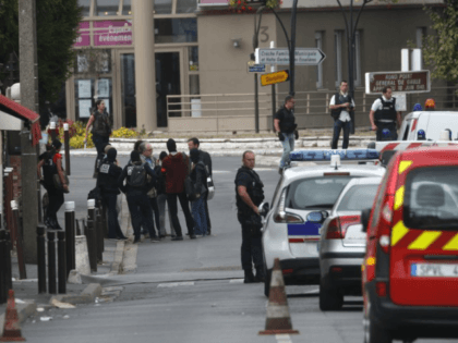 French police officers stand outside a building in Villejuif, south of Paris, Wednesday, S