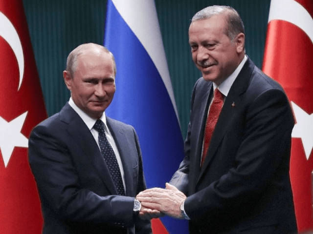 Turkish President Recep Tayyip Erdogan (R) and Russian President Vladimir Putin (L) shake hands after a joint press conference following their meeting at the Presidential Complex in Ankara on September 28, 2017