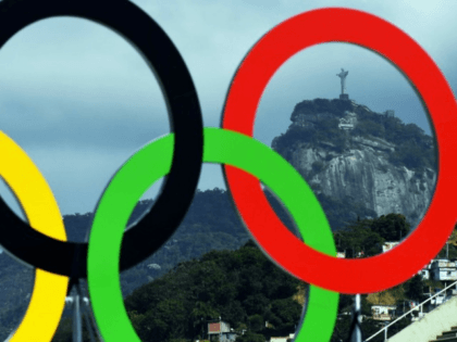 The Christ the Redeemer statue is seen through a set of Olympic rings in Rio de Janeiro