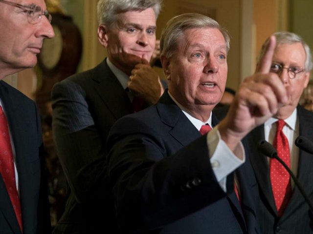Sen. Lindsey Graham, R-S.C., joined by, from left, Sen. John Barrasso, R-Wyo., Sen. Bill Cassidy, R-La., and Senate Majority Leader Mitch McConnell, R-Ky., speaks to reporters as they faced assured defeat on the Graham-Cassidy bill, the GOP's latest attempt to repeal the Obama health care law, at the Capitol in …