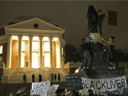 Protesters cover a statue of Thomas Jefferson with black tarp in front of the rotunda at the University of Virginia on Sept. 12, the one-month anniversary of the “Unite the Right” rally in Charlottesville. (Zack Wajsgras/Daily Progress/AP)