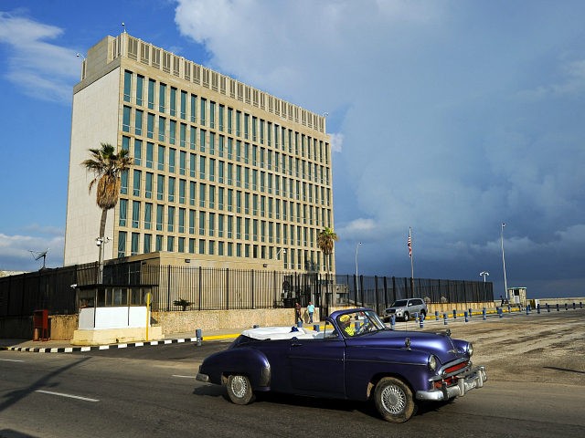 An old American car passes by the US Embassy in Havana on December 17, 2015. The United St