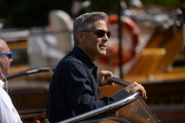 George Clooney arrives on a taxi-boat at the Excelsior Hotel during the 74th Venice Film F