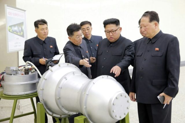 North Korean leader Kim Jong-Un was pictured inspecting a device at the nation's Nuclear Weapons Institute