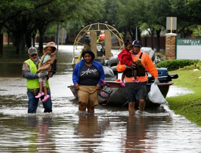 Local residents are evacuated on an air boat operated by volunteers from San Antonio, in t