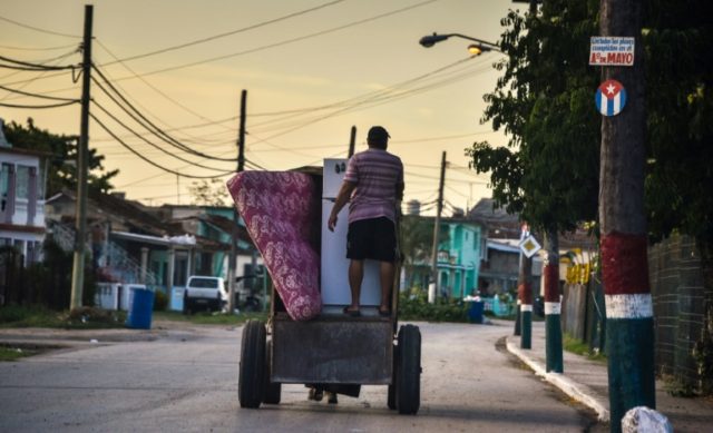 Cubans in the seaside town of Caibarien cart their belongings for safekeeping as they prep