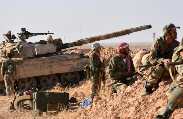 Syrian pro-government forces hold a position near the village of al-Maleha, in the norther